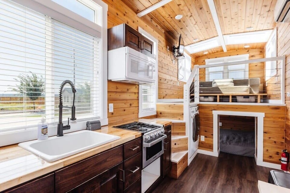 The kitchen is fully equipped with a refrigerator, freezer, microwave, stove and oven, and sink with hot/cold water. Enjoy coffee from the coffee maker, with cookware, dishes, utensils, and plenty of storage cabinets to keep everything organized.