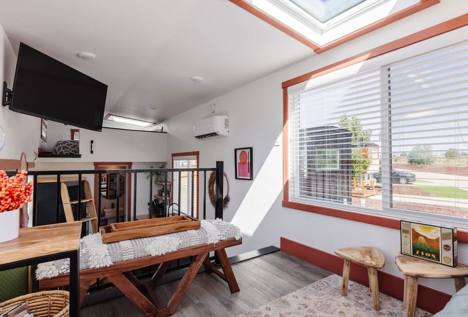 Relax in the cozy seating area surrounded by large windows and skylights. Natural light, comfortable furnishings, and an open layout create the perfect place to unwind between adventures.