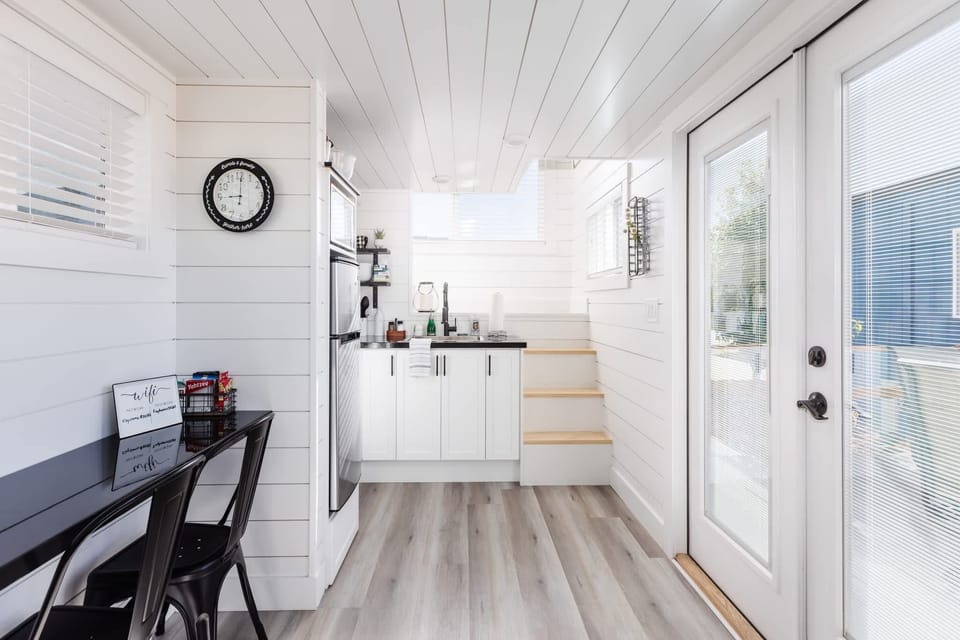The kitchen is fully equipped with a refrigerator, freezer, microwave, cooktop, and sink with hot/cold water. Enjoy coffee from the coffee maker and ample counter space. Essentials include cookware, dishes, utensils, and plenty of storage cabinets.