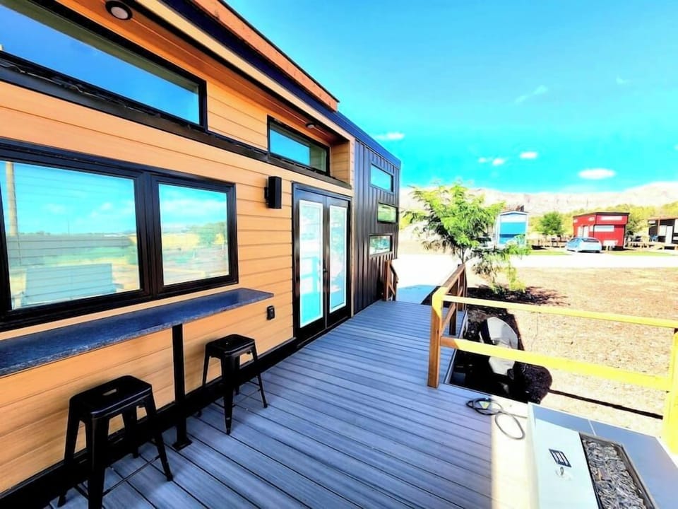 Relax on the spacious outdoor deck featuring a BBQ grill, a cozy fire pit, and a table with chairs for outdoor dining. Perfect for gatherings, this inviting space offers a great spot to cook, dine, and unwind while enjoying the fresh air.