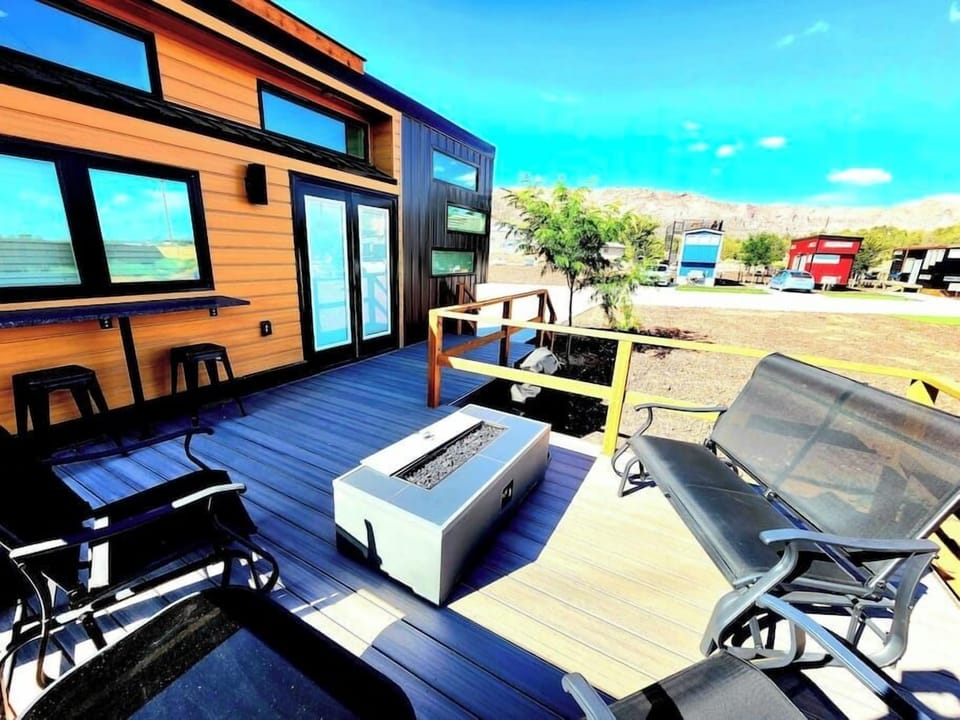 Relax on the spacious outdoor deck featuring a BBQ grill, a cozy fire pit, and a table with chairs for outdoor dining. Perfect for gatherings, this inviting space offers a great spot to cook, dine, and unwind while enjoying the fresh air.
