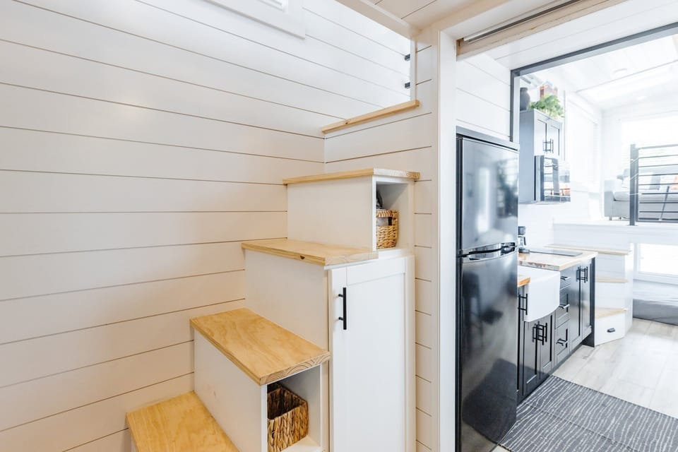 The kitchen is fully equipped with a refrigerator, freezer, microwave, stovetop, and sink with hot/cold water. Enjoy coffee from the coffee maker, with cookware, dishes, utensils, and plenty of storage cabinets to keep everything organized.
