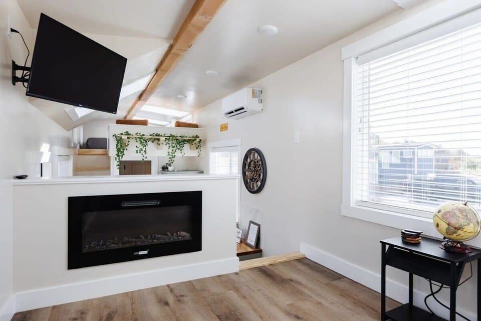 Inviting living room featuring a comfortable couch, a cozy fireplace, and a TV for entertainment. A sofa bed provides extra sleeping space, and with Wi-Fi access, this space is perfect for unwinding or enjoying your favorite shows and movies.