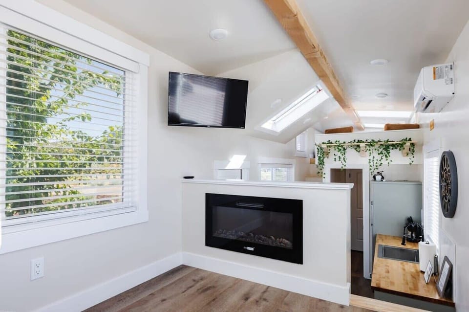 Inviting living room featuring a comfortable couch, a cozy fireplace, and a TV for entertainment. A sofa bed provides extra sleeping space, and with Wi-Fi access, this space is perfect for unwinding or enjoying your favorite shows and movies.