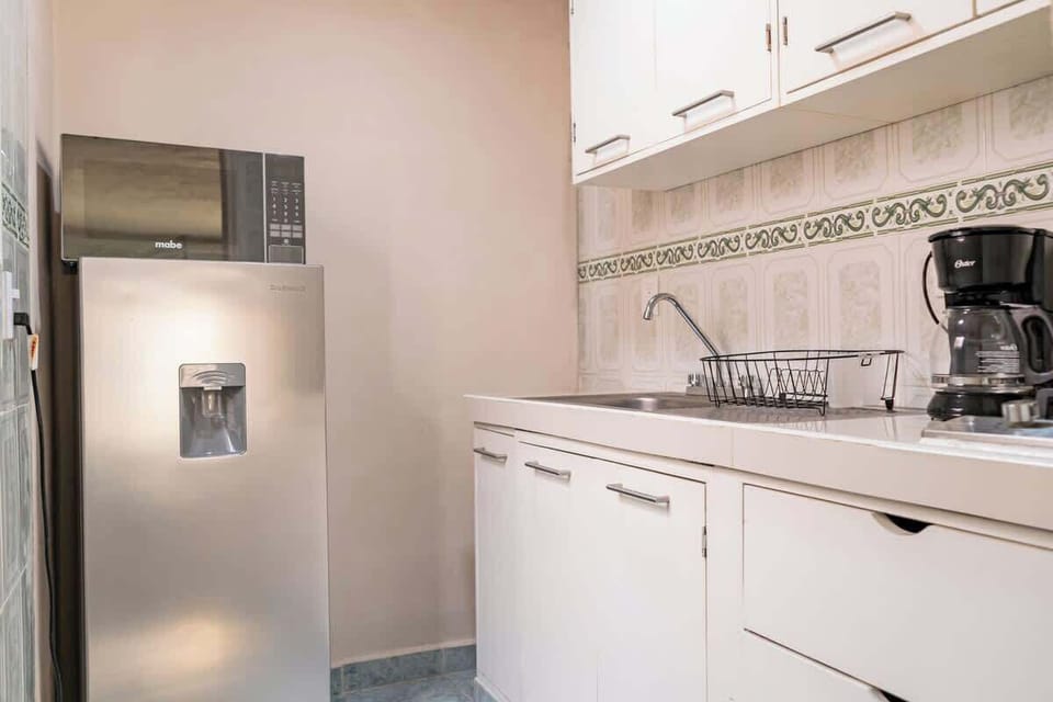 Kitchenette with coffee maker and essentials