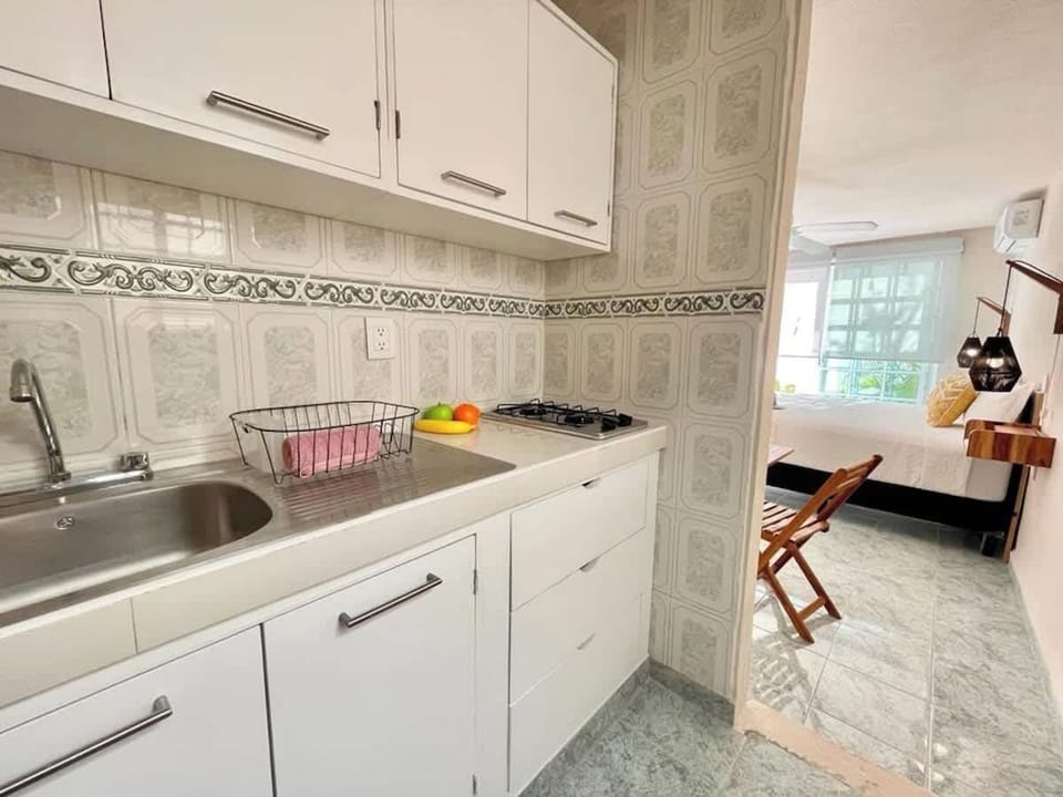 Kitchenette with white cabinetry