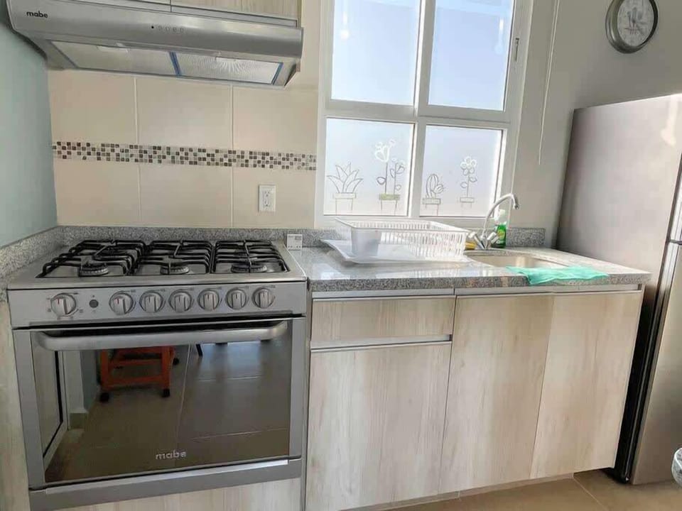 Fully equipped kitchen with stove and oven
