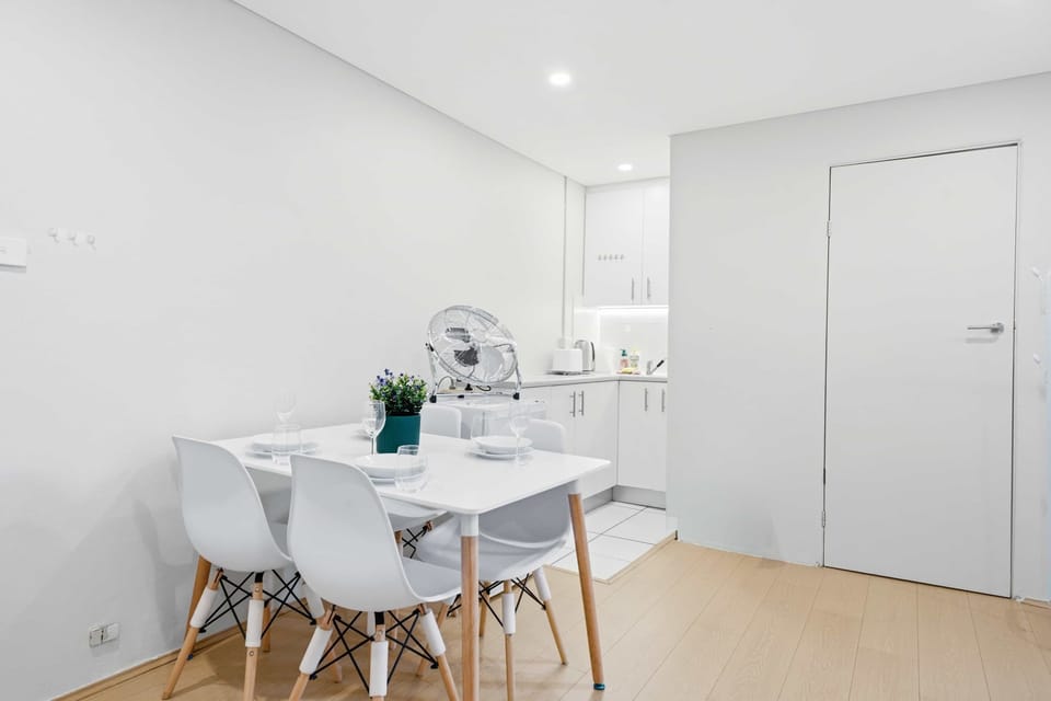 Compact dining space with table and chairs, perfect for meals or remote work.