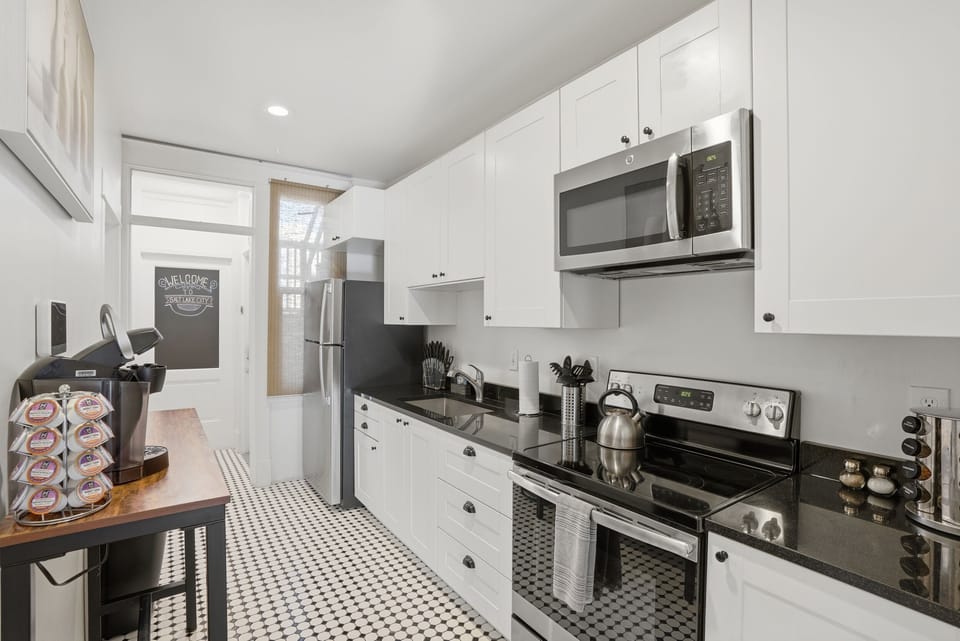 Galley kitchen stocked with all you need to cook, dine and get your coffee fix.