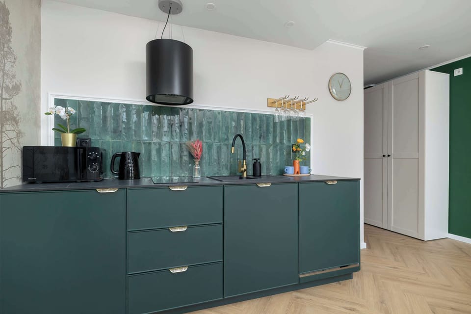 Close-up of textured green cabinetry and decorative kitchen accessories.