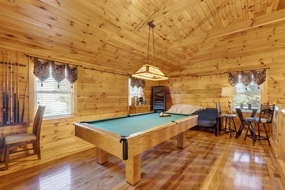 Upper-level game area with a full-sized pool table and arcade.