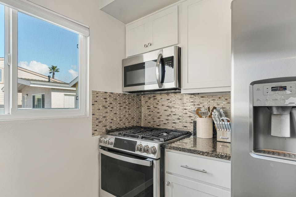 Fully equipped kitchen with bar seating, ideal for cooking, dining, and gathering.