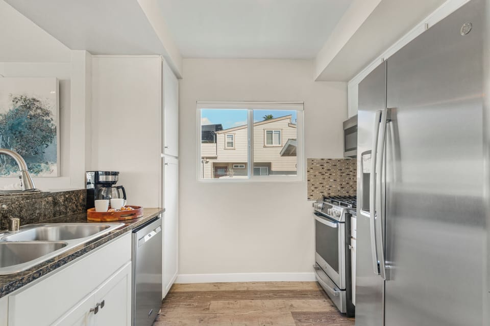 Fully equipped kitchen with bar seating, ideal for cooking, dining, and gathering.