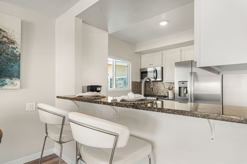 Bright, open kitchen with breakfast bar seating—perfect for easy mornings and casual meals.
