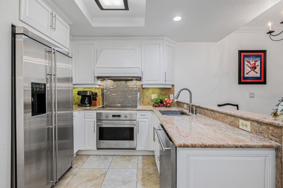 Modern kitchen with spacious countertops and stainless steel appliances.
