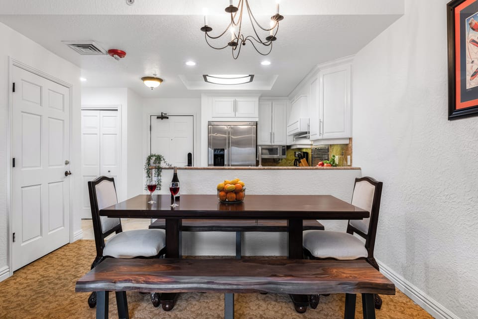 View of the dining area and kitchen breakfast bar.