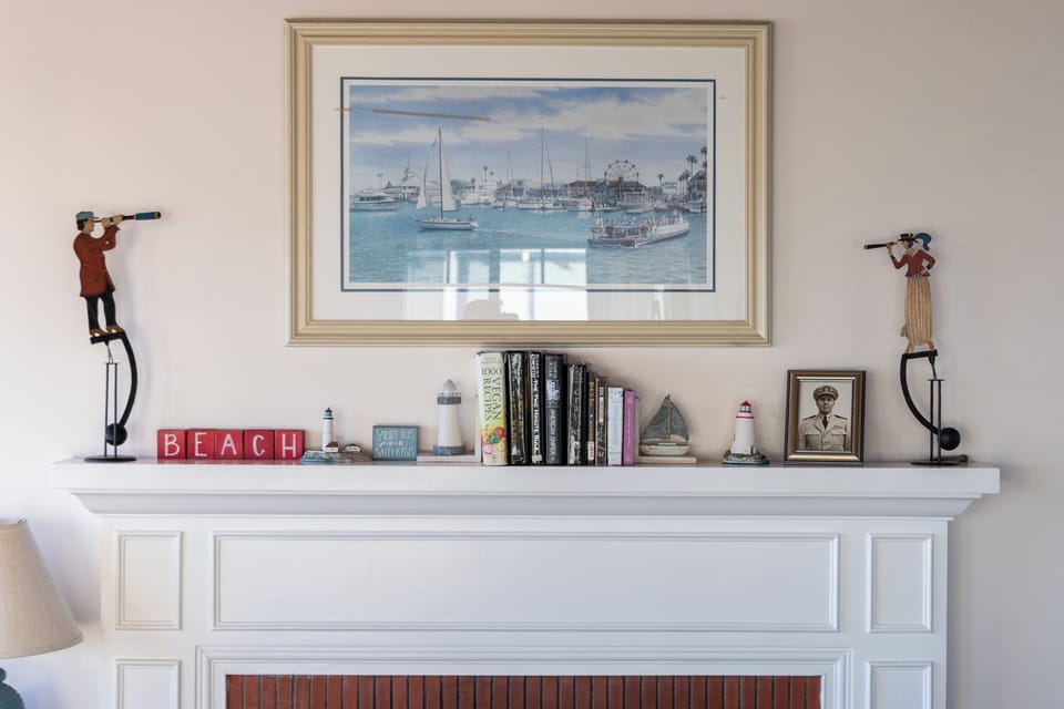 Tasteful coastal artwork and curated details add character to the living space.