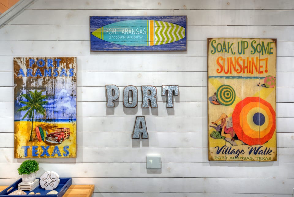 Playful coastal artwork adds a cheerful local touch, bringing Port Aransas character and beach-town charm into the heart of the home.