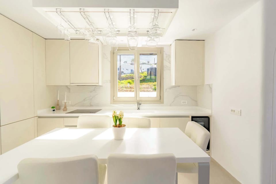 Bright kitchen and dining area with clean white finishes