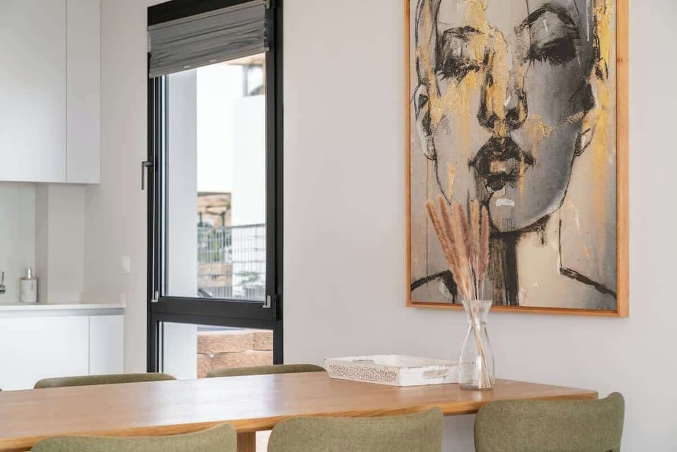 Dining area with a table and chairs, offering a comfortable space to enjoy meals while staying connected with the kitchen and living areas.