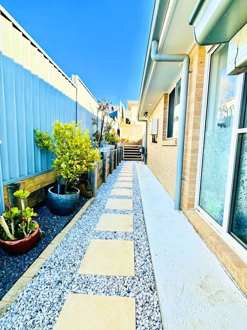 Short outdoor paver steps lead to the front door, well-lit and easy to see