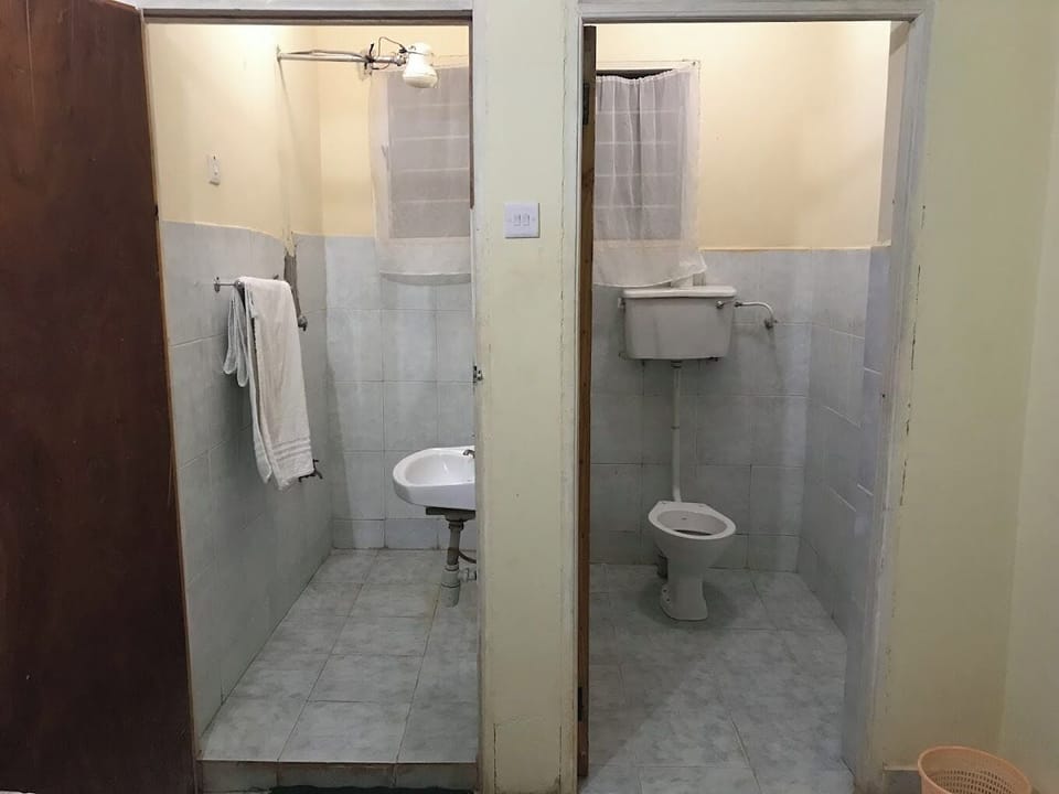 Standard Double Room | Bathroom | Shower, slippers, towels, soap
