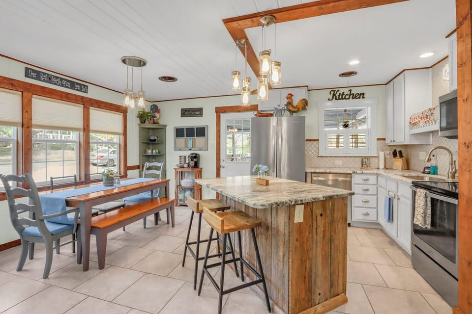 Your spacious farmhouse kitchen features granite countertops, stainless steel appliances, and charming rustic island where you'll love gathering for meals.