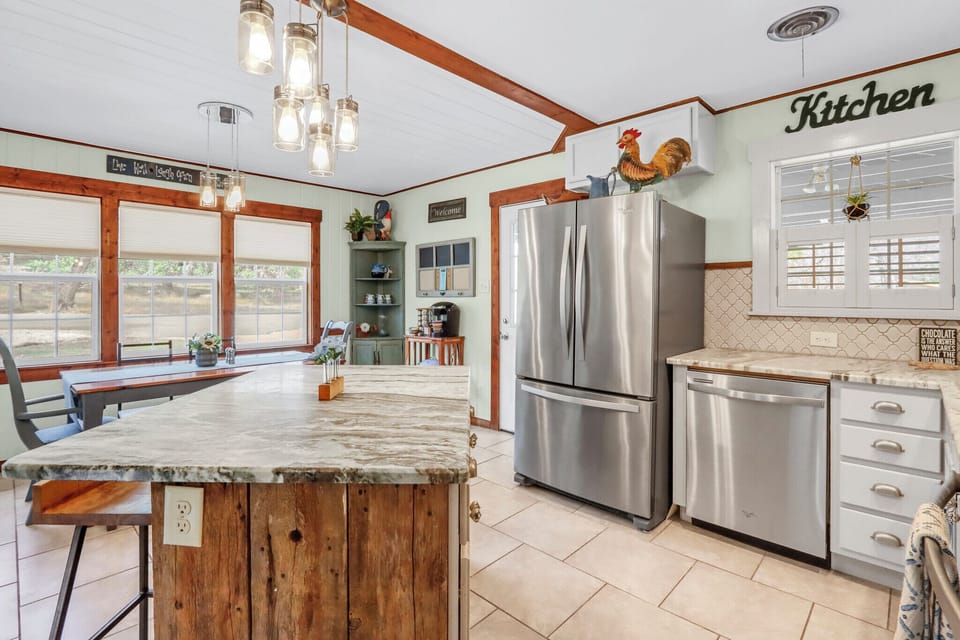 Gather around the inviting farmhouse kitchen island where rustic charm meets modern appliances—perfect for morning coffee or evening conversations.