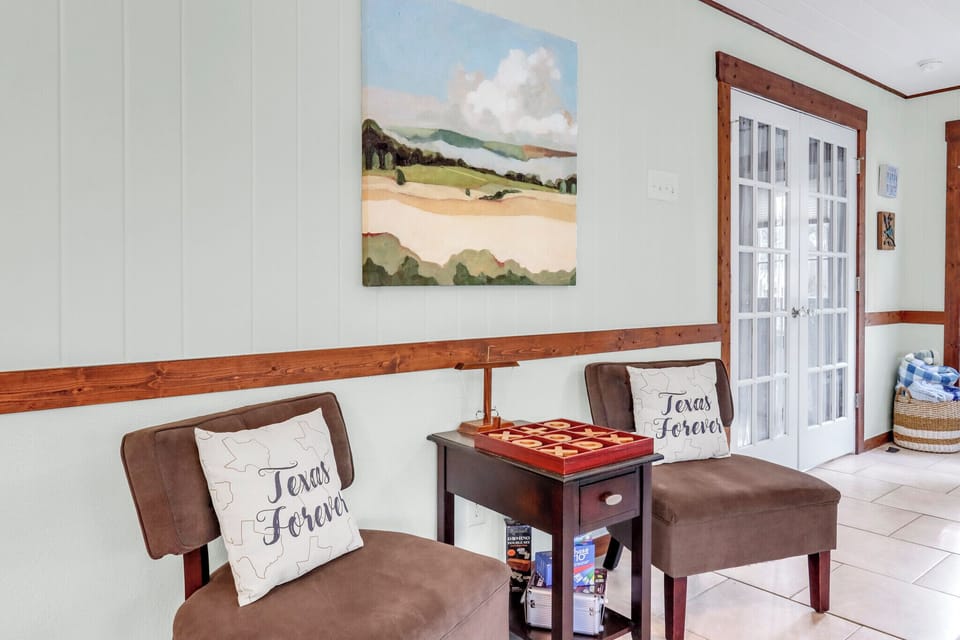Relax in your cozy seating area with Texas-themed decor, beautiful landscape artwork, and a checkers table for friendly games together.