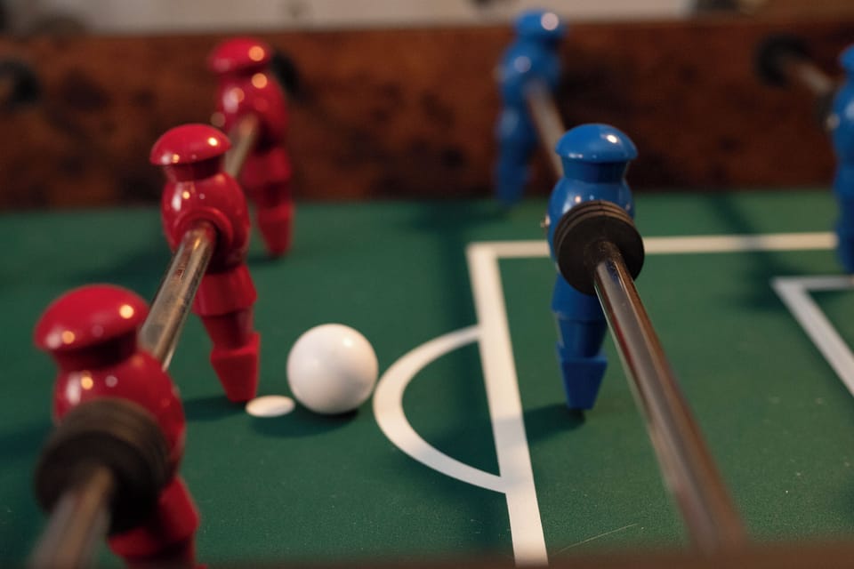 Challenge your friends to competitive foosball matches in your game room entertainment space.