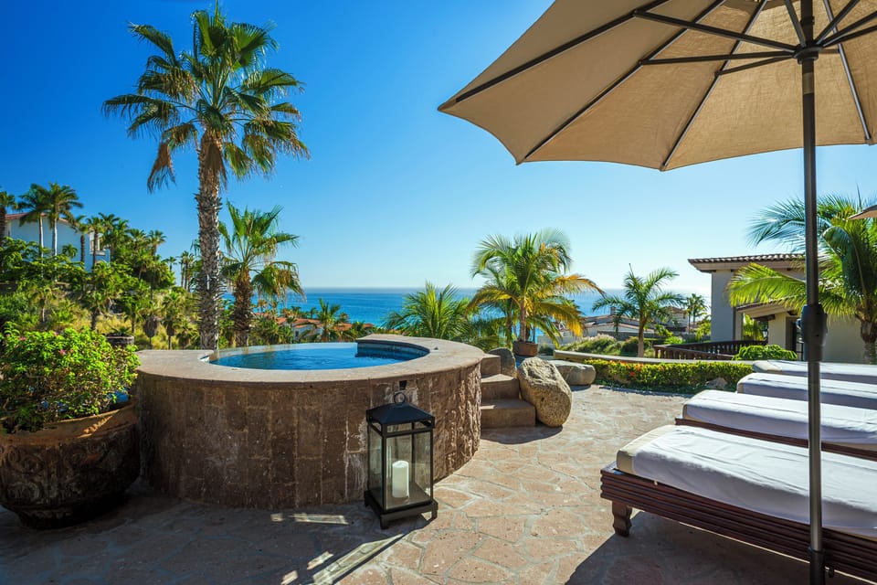 Sunny patio with jacuzzi and ocean views