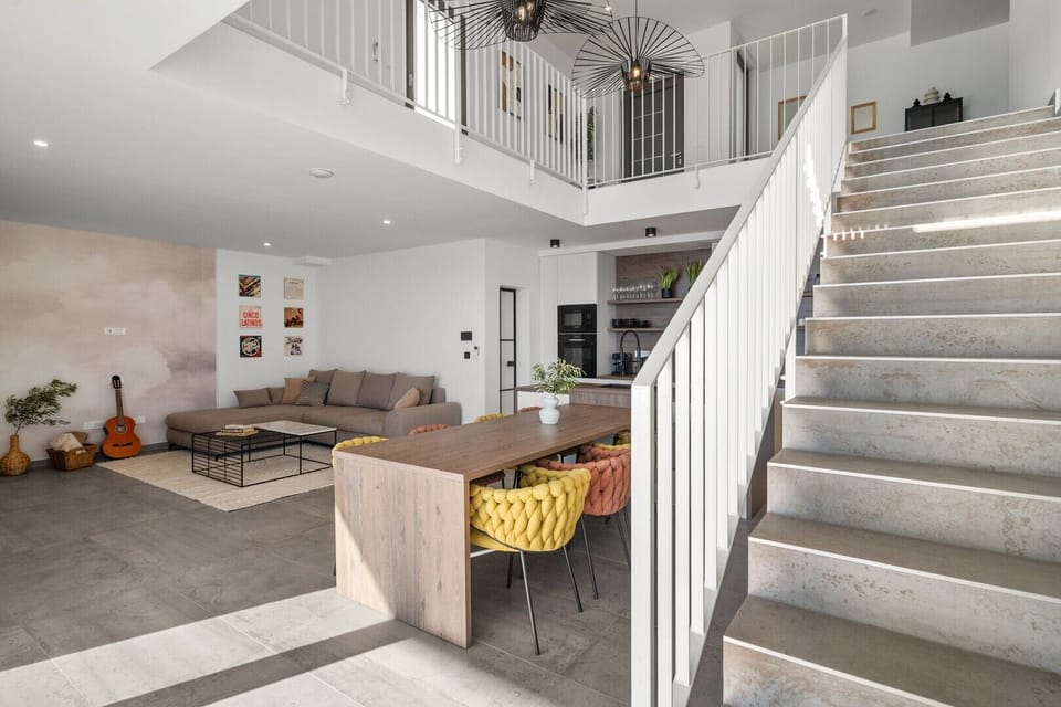 Spacious 60 sqm open-plan living area with a fully equipped kitchen and island.
