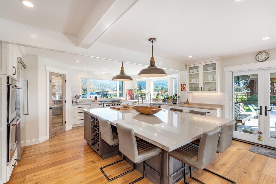 Your spacious kitchen features gleaming counters, modern appliances, and stunning mountain views through oversized windows.