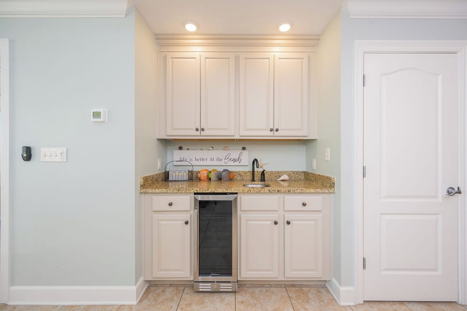 Create refreshing drinks from the wet bar while admiring the beach decor and vibrant accents