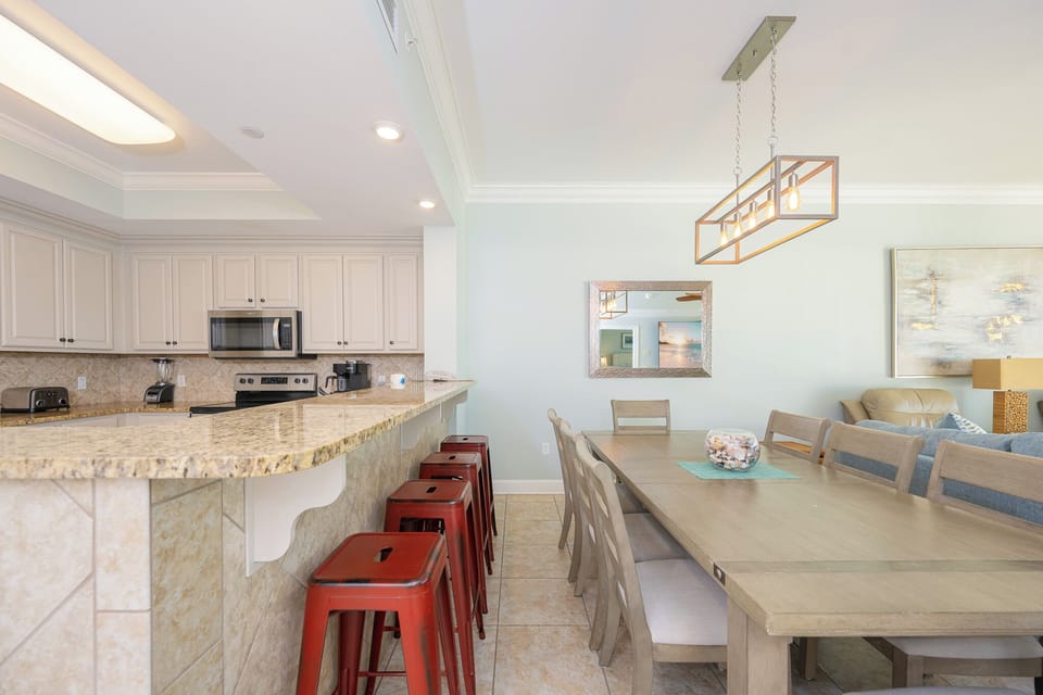 Sip your morning coffee at the breakfast bar and get ready for a beach day in this stylish space