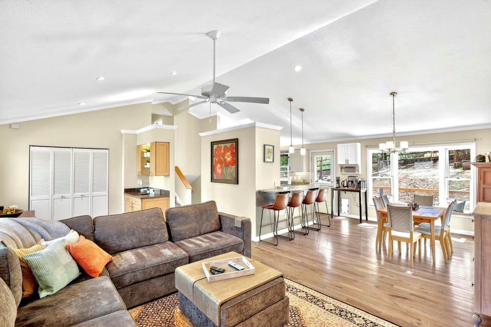 Bright open-concept living area with vaulted ceilings and spacious dining
