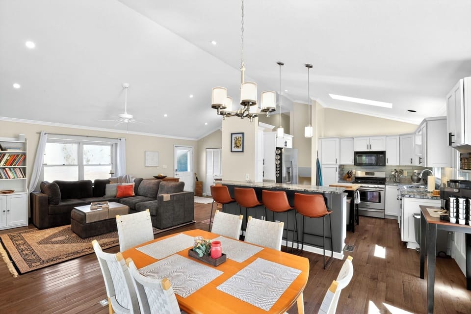Bright open-concept kitchen, dining & living area with stylish breakfast bar