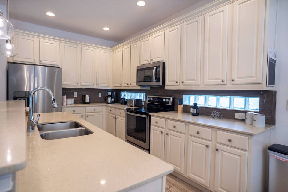 Enjoy a bright kitchen with creamy white cabinetry and stainless steel appliances that inspire your culinary creativity. Spacious countertops provide ample room for meal prep, enhanced by a unique window design that floods the.