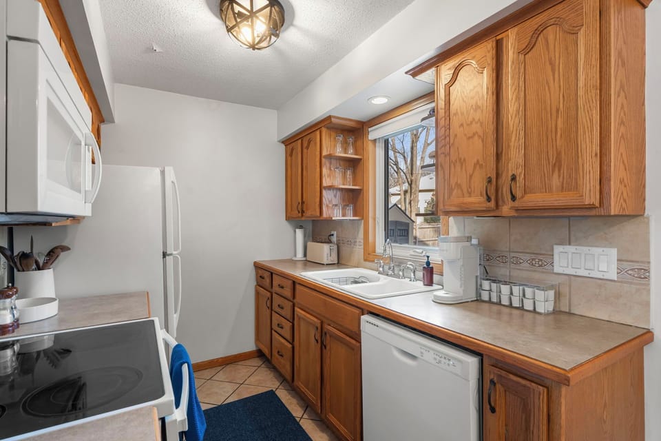 Your fully equipped kitchen awaits with rich wood cabinets, modern appliances, and everything you need to create memorable meals during your stay.