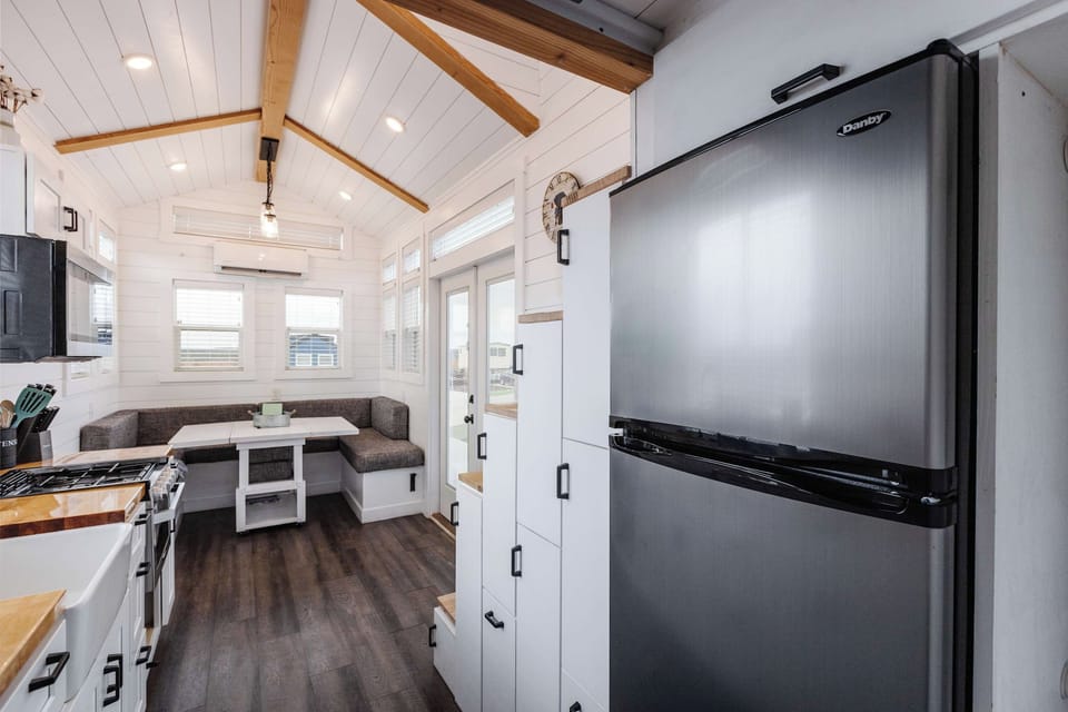 Full-size refrigerator and freezer offer plenty of space for groceries, making this tiny home ideal for longer stays and family trips near Zion National Park.