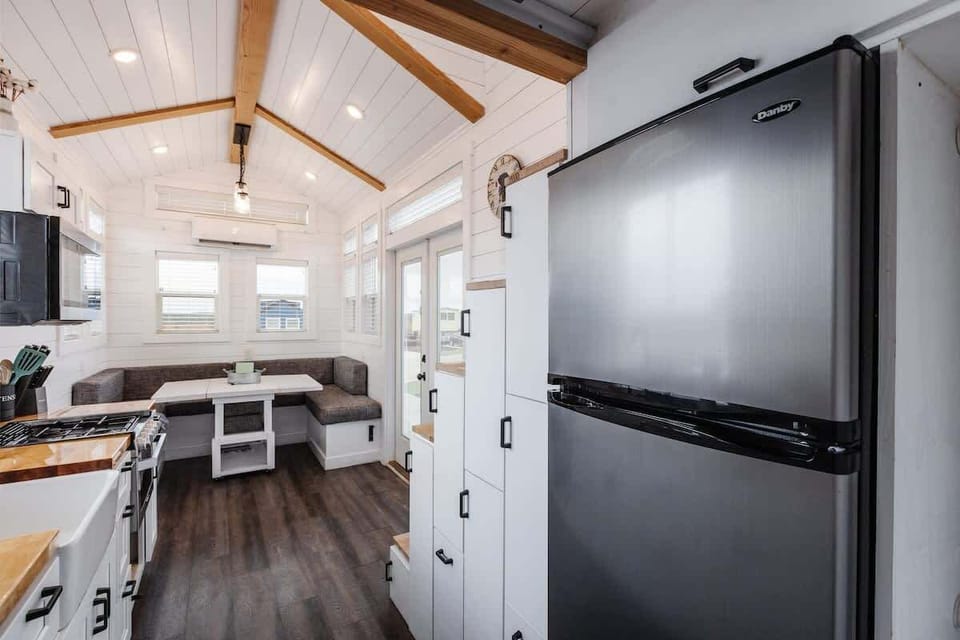 Full-size refrigerator and freezer offer plenty of space for groceries, making this tiny home ideal for longer stays and family trips near Zion National Park.