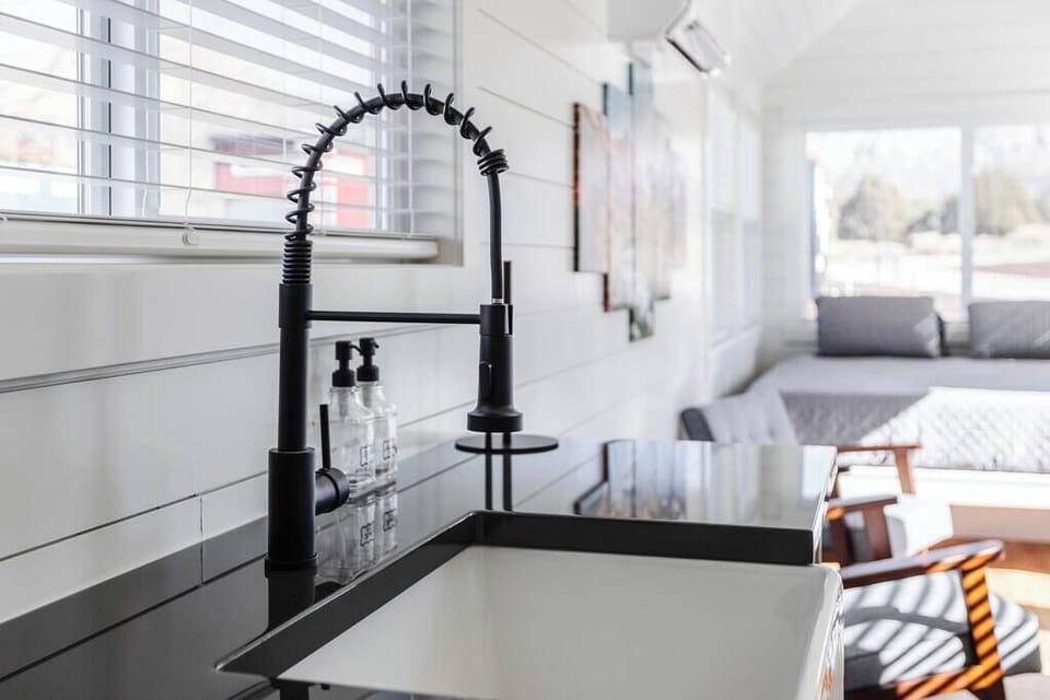 The kitchen is fully equipped with a refrigerator, freezer, microwave, cooktop, and sink with hot/cold water. Enjoy coffee from the coffee maker and ample counter space. Essentials include cookware, dishes, utensils, and plenty of storage cabinets.