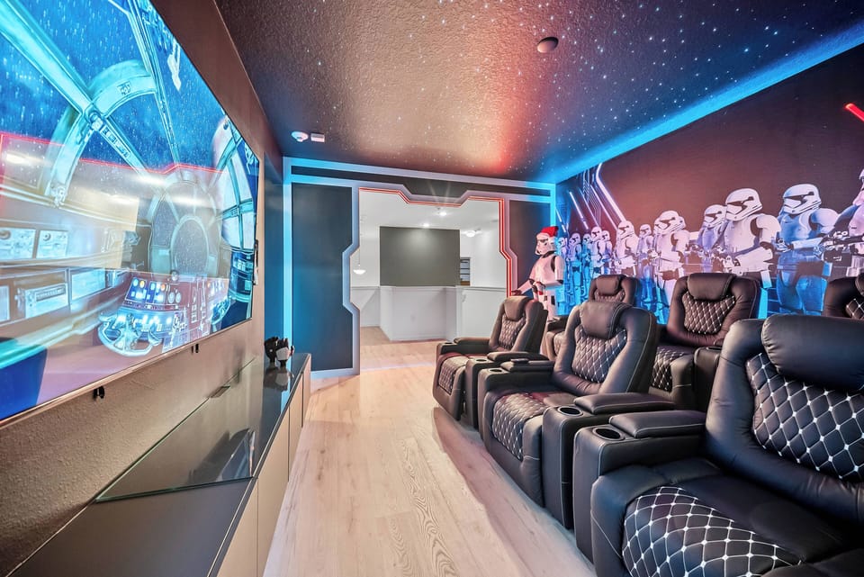 Experience your own private cinema with plush reclining seats and captivating blue lighting for a memorable atmosphere. Enjoy movie nights or gaming sessions with friends on a large screen that promises immersive entertainment.