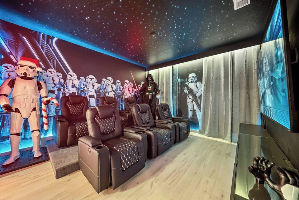 Experience a cinematic paradise with plush leather recliners that offer relaxation amidst a stunning backdrop of iconic characters and starry skies, creating a captivating atmosphere perfect for unforgettable movie nights.