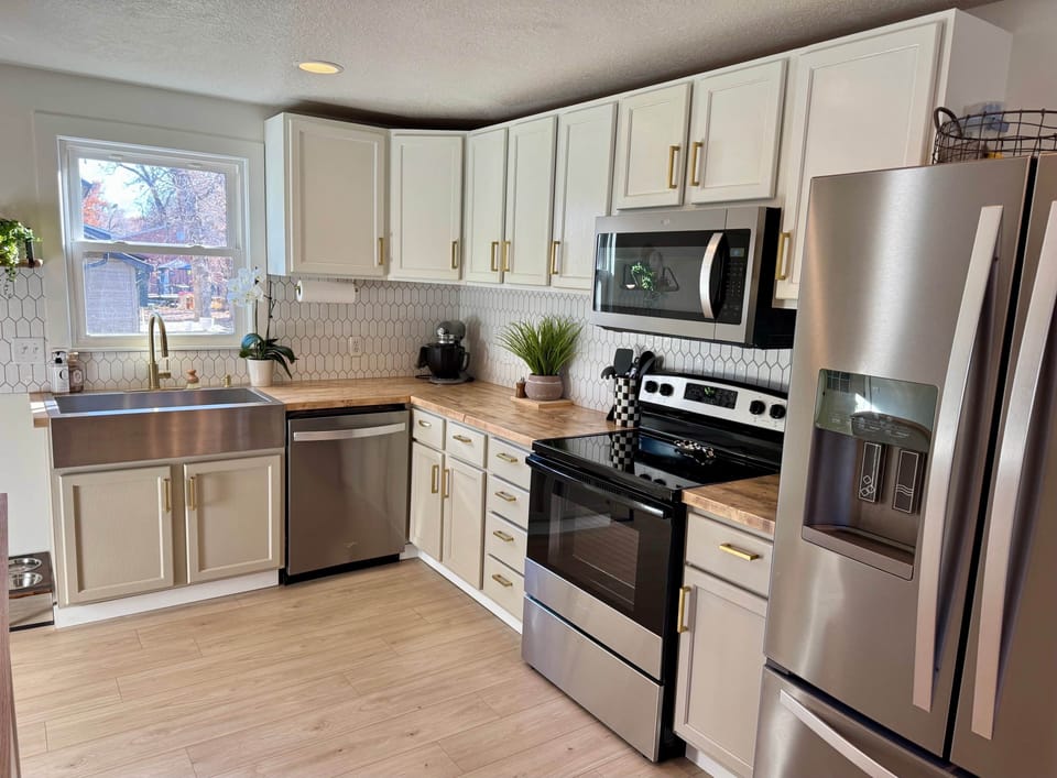 Fully stocked, newly renovated kitchen, featuring dishwasher, fridge/freezer, oven/stove and more.