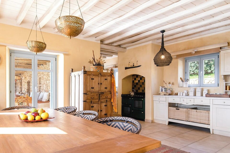 The kitchen seen from the dining area. French doors open out onto the terraces.