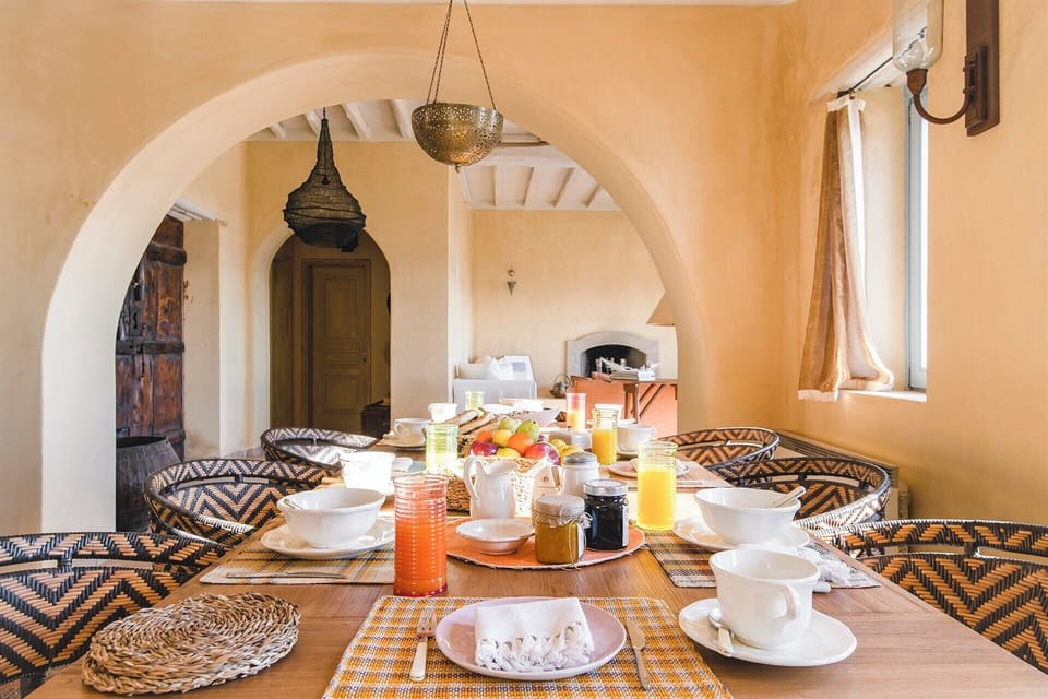 A wide arch connects the main house's living area with its dining area.