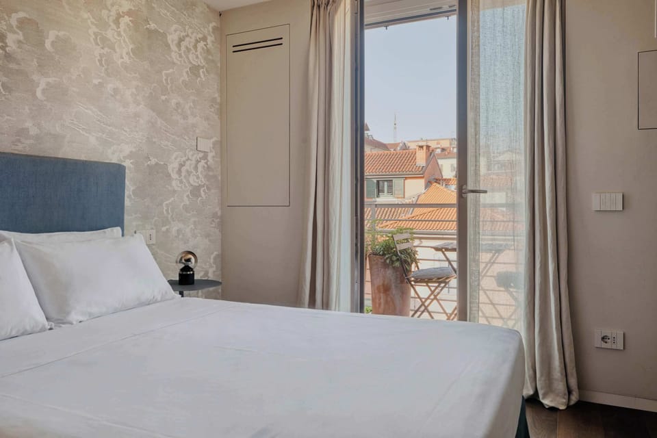 Stylish bedroom with private access to the balcony—perfect for fresh mornings and relaxing city views.