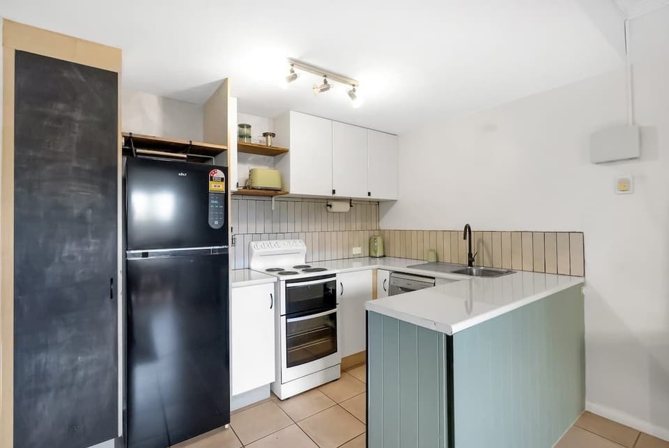 Cook with ease in the fully equipped kitchen featuring a stove, oven, microwave, dishwasher, and all your cooking basics.