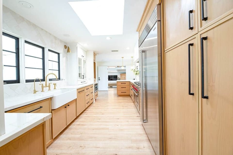 The newly remodeled kitchen has it all: blender, air fryer, Wolf range, Subzero refrigerator & a big farmhouse sink.